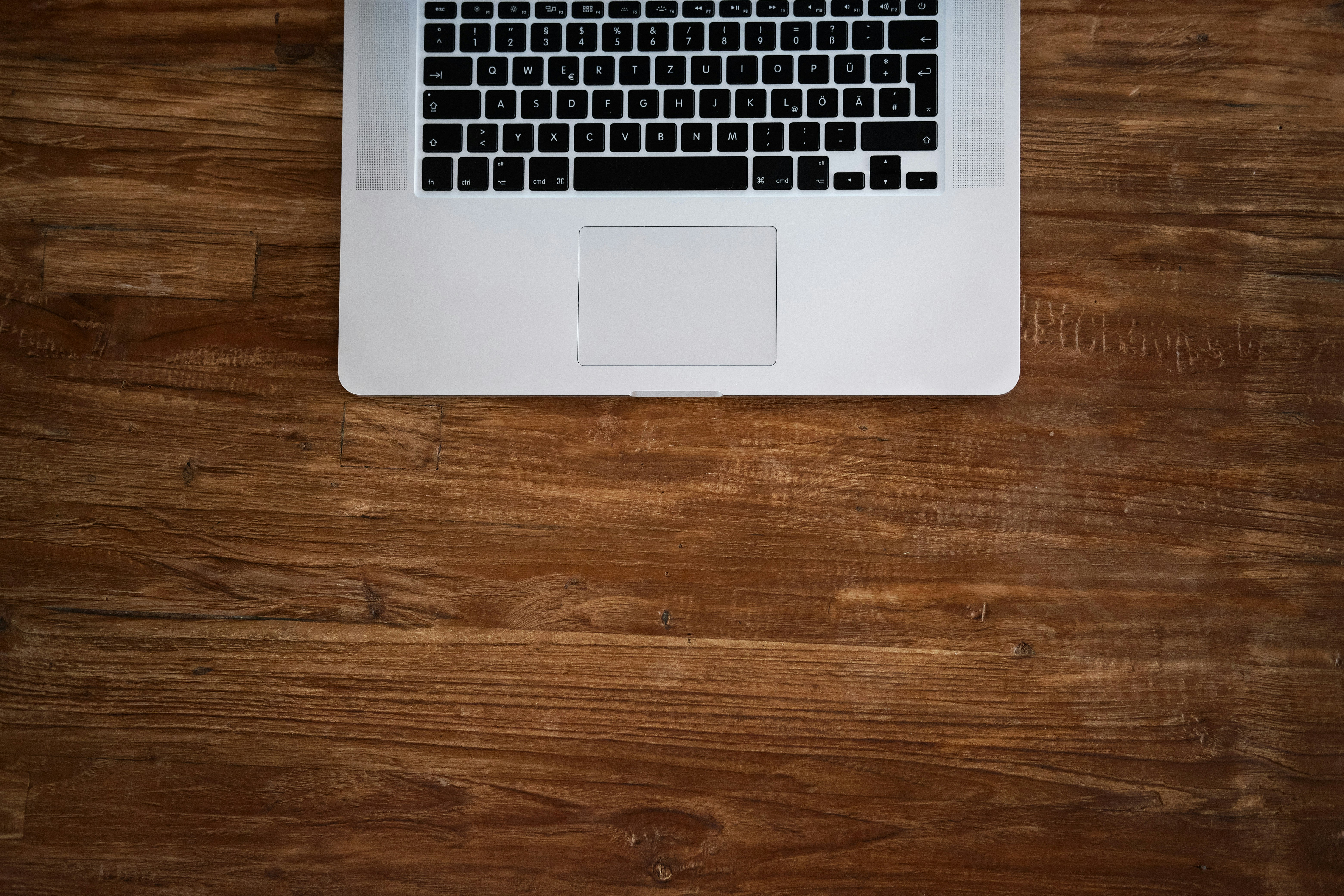 macbook pro on brown wooden table